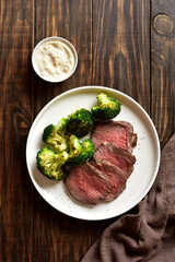 Beef steak served with roasted broccoli