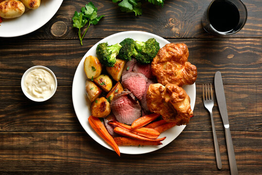 Sunday Roast with roasted beef, carrots, crispy potato, broccoli and yorkshire pudding