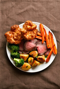 Sunday Roast with roasted beef, carrots, crispy potato, broccoli and yorkshire pudding