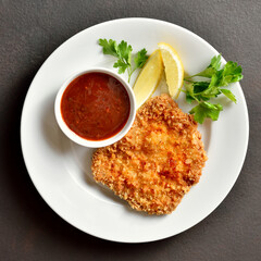 Schnitzel with lemon and leaves of parsley