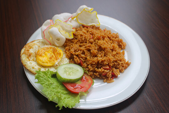 Appetizing Plate of Indonesian Nasi Goreng on Dark Wood