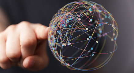 Abstract image of a hand touching a colorful network globe. Represents connection, technology, global communication and innovation. Ideal for il