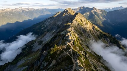 Majestic Mountain Range with Cloud Cover and Green Valleys.