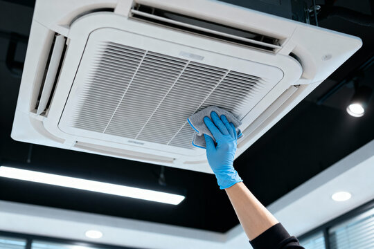 Cleaning an air conditioning unit with a microfiber cloth for maintenance