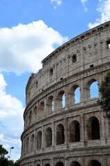 Fototapeta premium Rome, Italy 09.02.2019: Colosseum (Coliseum) is one of main travel attraction of Rome, Italy. Ancient Roman ruins of Colosseum, landscape of old Rome city, Italy.