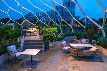 Open air roof top restaurant at night in Bangkok, Thailand.