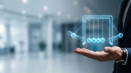 Newton cradle hologram floating above businessman hand in modern office, symbolizing balance and motion energy