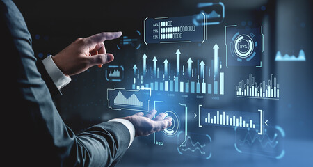 Businessman interacting with futuristic data dashboard interface showing analytical graphics and charts on digital background concept.