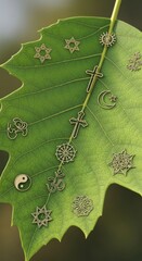 Religious symbols arranged on a green leaf, representing diverse spiritual beliefs.