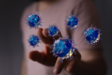 An artistic representation of a hand interacting with digital virus models. Perfect for medical, scientific an