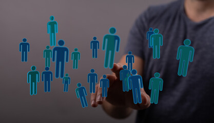 Concept of connection, teamwork, networking, hand interacting with digital people icons, technology, and global