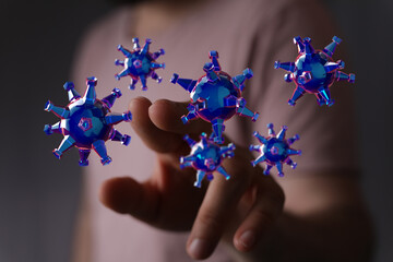 Artistic depiction of a hand interacting with a digital coronavirus model. Symbolic representation of healthca