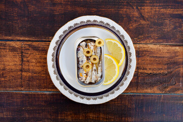 Can of canned oil sardines on a elegant plate