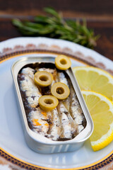 Can of canned oil sardines on a elegant plate