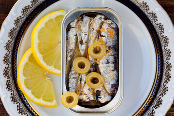 Can of canned oil sardines on a elegant plate