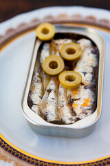 Can of canned oil sardines on a elegant plate