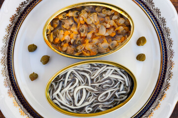 Cans of preserves with elvers and cockles