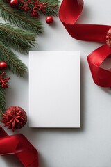 Blank holiday card with red ribbon and pine branches top view
