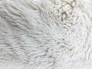 White fluffy carpet texture background, soft fur fabric top view