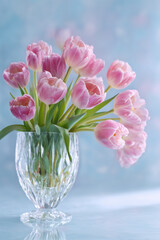 Pink tulip flowers in crystal vase