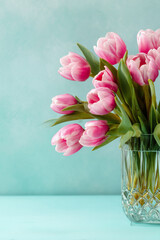 Pink tulip flowers in crystal vase