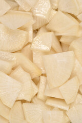 A close up shot of white sliced black radish pieces for a healthy salad