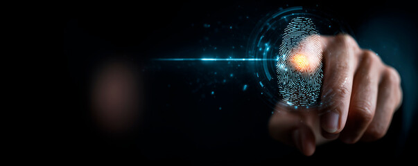 Person using fingerprint scanner technology on dark background with hand gesture highlighting security and authentication concept in digital world