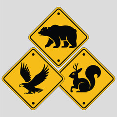 Distinctive yellow diamondshaped road warning signs featuring silhouettes of wild forest animals including bear eagle and antlered squirrel