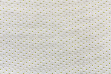 abstract background of white and olive polka dot knit fabric texture close up