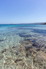 Rocks and water on the beach of San Silverio, Sardinia, Italy.