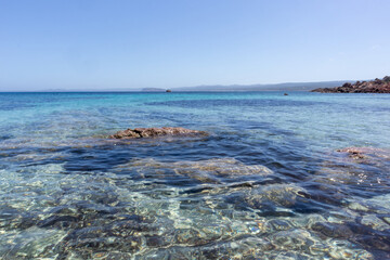 Rocks and water on the beach of San Silverio, Sardinia, Italy.