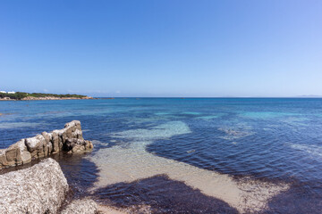 Rocks and water on the beach of San Silverio, Sardinia, Italy.