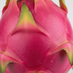Close up of vibrant pink dragon fruit skin with green tips