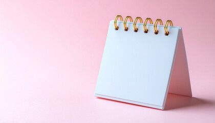Blank pink spiral notebook with an empty white page for your business message or reminder list