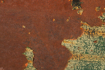 Detail of rusty metal sheet with scraps of flaking paint