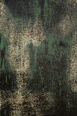 Old metal sheet splashed with green, black and white paint