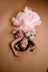 photo session of a girl in a bouquet of fresh flowers