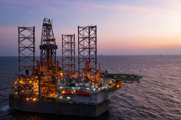 Aerial view of offshore jack up rig in a shipyard during sunset for oil and gas exploration and...