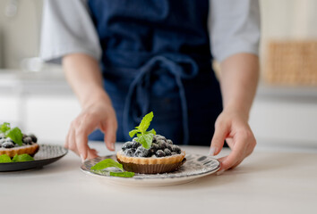 Girl Holding Blueberry Dessert