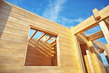 Building a wooden house on the construction site.