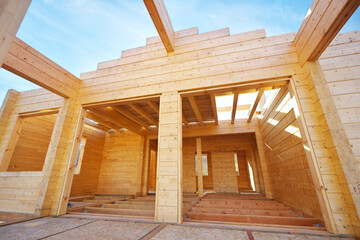 Building a wooden house on the construction site.
