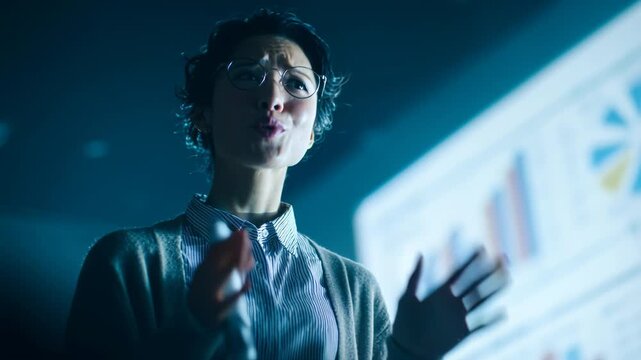 Young woman presenting data and explaining results in business meeting