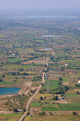 Mhaismal, MH, India, Dec 12, 2025 Panoramic view of rural farmland, patchwork agricultural fields, small lakes and villages seen from a hilltop viewpoint