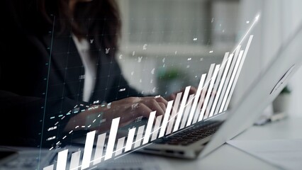 A professional businesswoman analyzes financial data on a laptop in a modern office. The digital graph showcases growth and market trends for informed decision-making. Copula