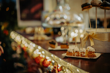 Sweet dessert cakes on a Christmas market stall in the evening
