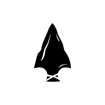 Black silhouette of an ancient stone arrowhead with a notched base, isolated on a white background.