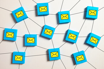 Blue blocks with envelope icons connected by lines, representing email marketing, newsletter distribution, global communication network, and digital messaging system.