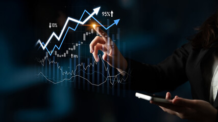 A businesswoman interacts with growth graphs and statistics while holding a smartphone in a modern office setting, emphasizing financial analysis and market trends. Scalp