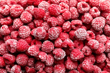 Frozen ripe raspberries as background, top view