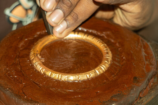 Crafted gold bangle or bracelet is shown, smooth, cylindrical made